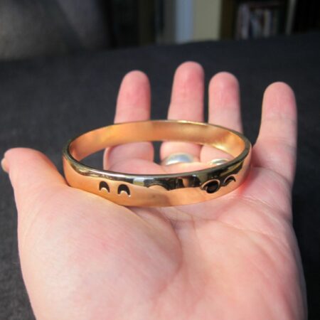 Cute, Unique gold tone bangle bracelet w/ eyes all around it emoji wink face