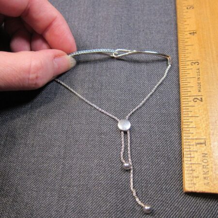 Gorgeous sterling silver pull-to-fit adjustable bracelet w/row of blue gemstones