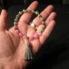 Cute pink and gray stone bead stretch bracelet w/ gray tassel gold tone beads